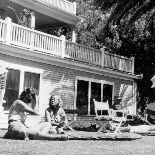 Black and white photo of women sitting in the sun at Castle Hot Springs lodge.