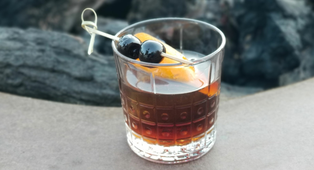 Old Fashioned Cocktail Sitting Atop Fire Pit