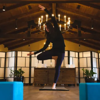 Woman Doing Yoga in a Serene Wooden Lodge
