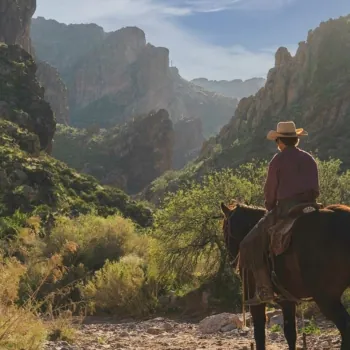 Man Riding Horse Among Smokey Arizona Mountains