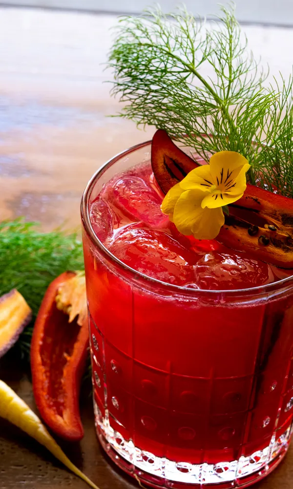 Tropical Pink Cocktail Topped with Fresh Dill and Red Pepper