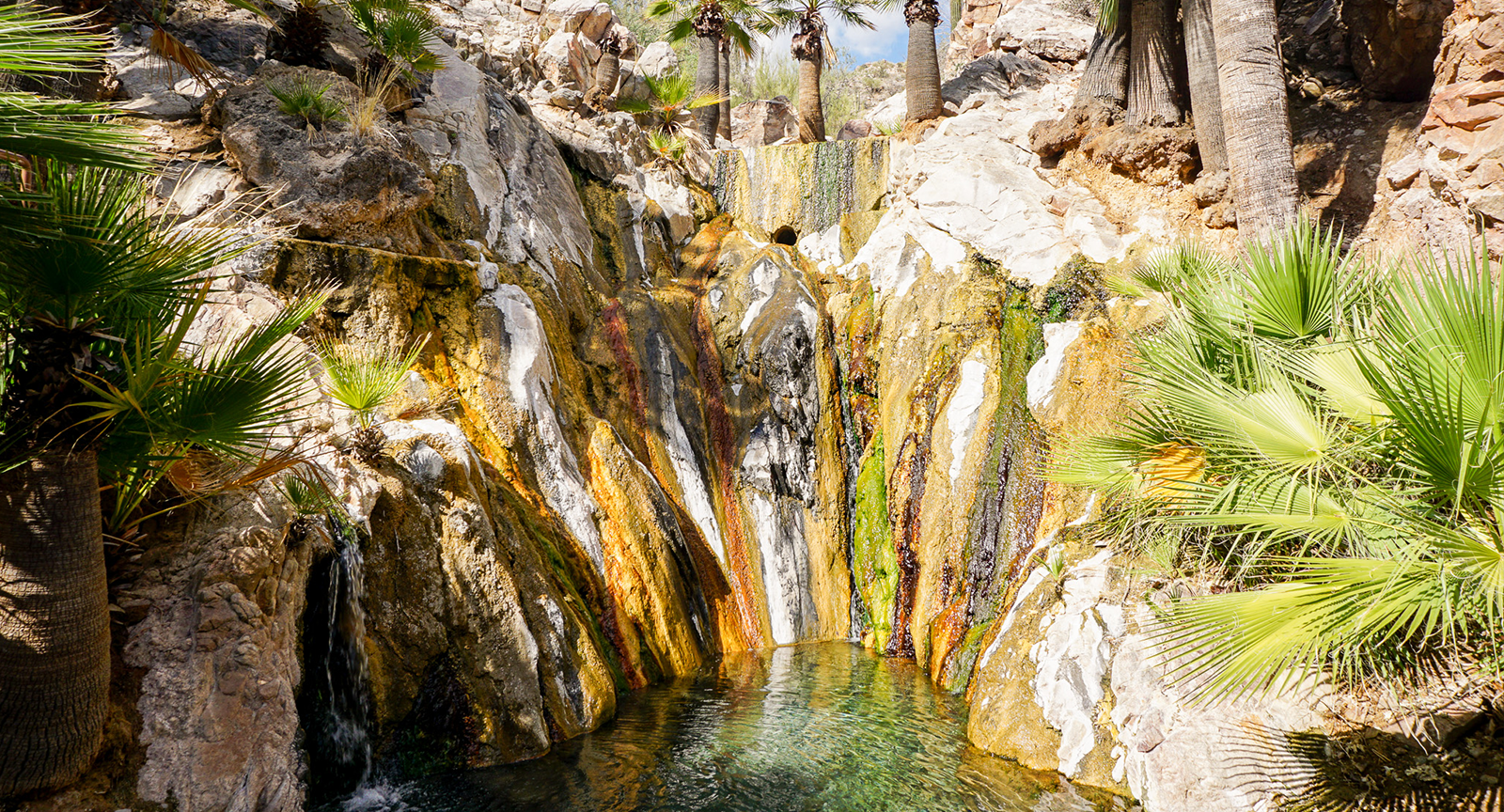 Rock walls surrounding mineral hot springs at Castle Hot Springs resort.