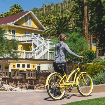 Woman Walking Bright Yellow Bike Past John F. Kennedy House