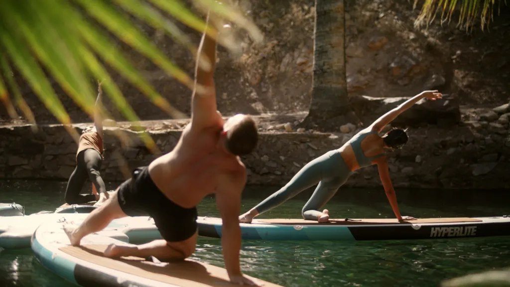 People doing yoga by the natural hot springs at Castle Hot Springs, a luxury wellness resort