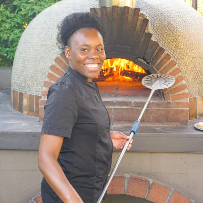 A chef next to a woodfire oven at Castle Hot Springs, a luxury inclusive resort
