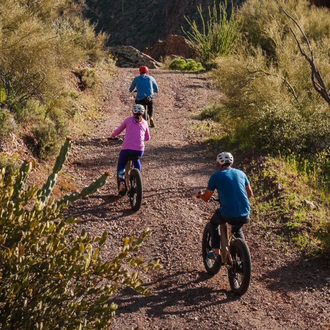 People biking yoga at Castle Hot Springs, a luxury wellness resort in Arizona
