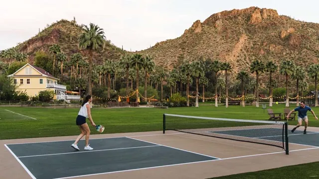 Two people playing pickleball