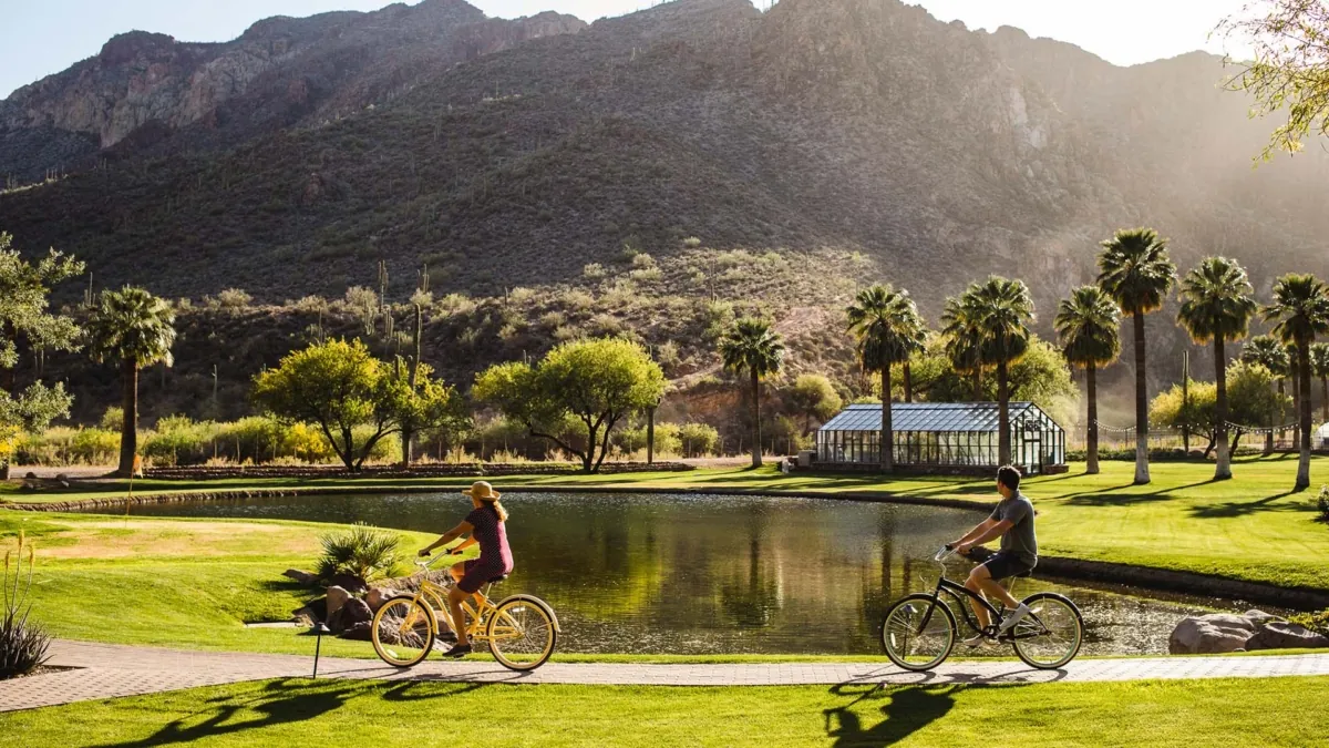 A couple riding resort cruiser bikes at Castle Hot Springs resort