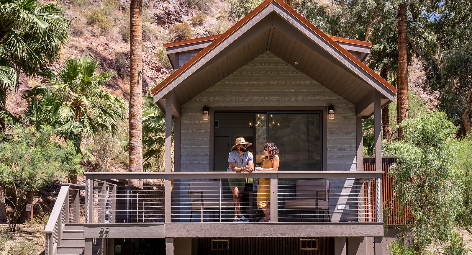 A couple standing outside an accommodation at Castle Hot Springs, a luxury Arizona resort