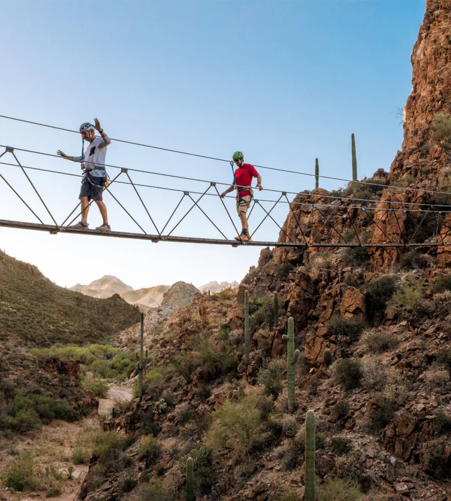 Two people crossing Arizona’s only Via Ferrata Adventure Course.