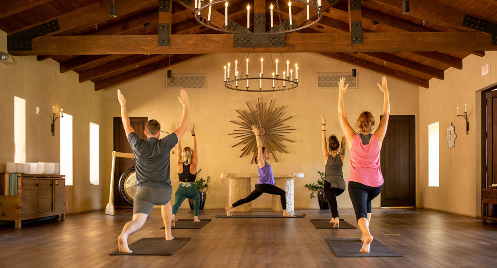 Group of people partaking in wellness activities and a yoga class at Castle Hot Springs.