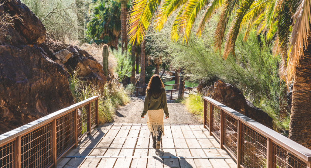 A woman walking through the desert at Castle Hot Springs.