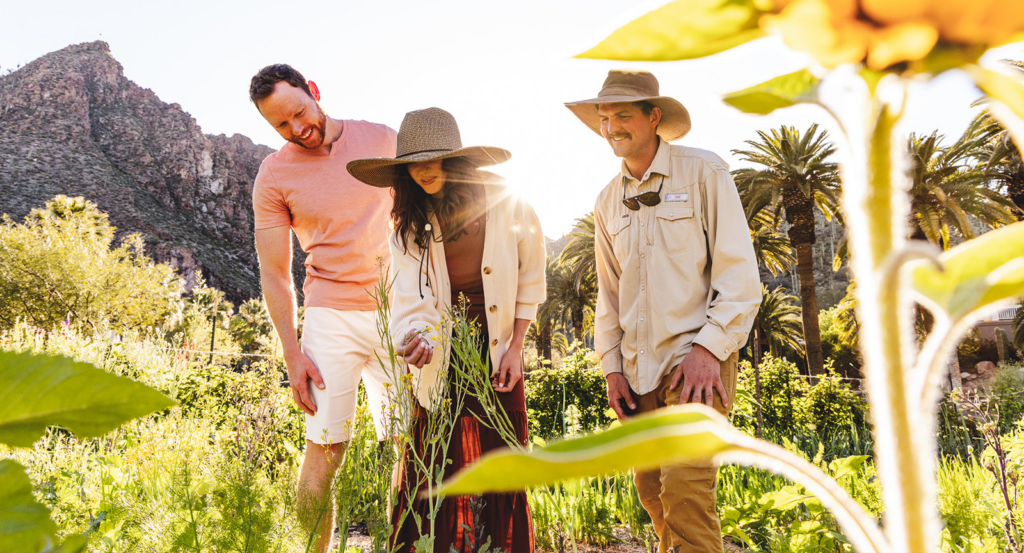 Three people enjoying a tour of The Farm at Castle Hot Springs