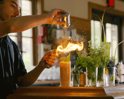 Animated GIF of Bartender at Bar 1896 making a flame over a cocktail