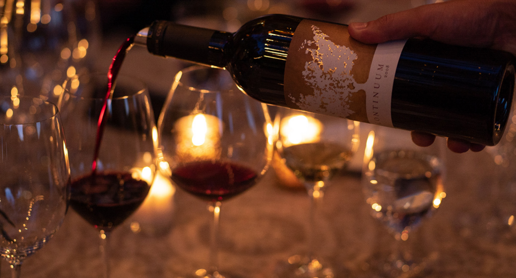 Pouring a glass of red wine during the Desert Vines culinary experience.