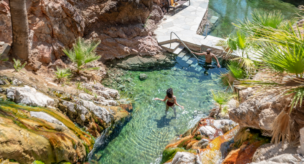 A couple soaking in the hot springs on an Arizona honeymoon