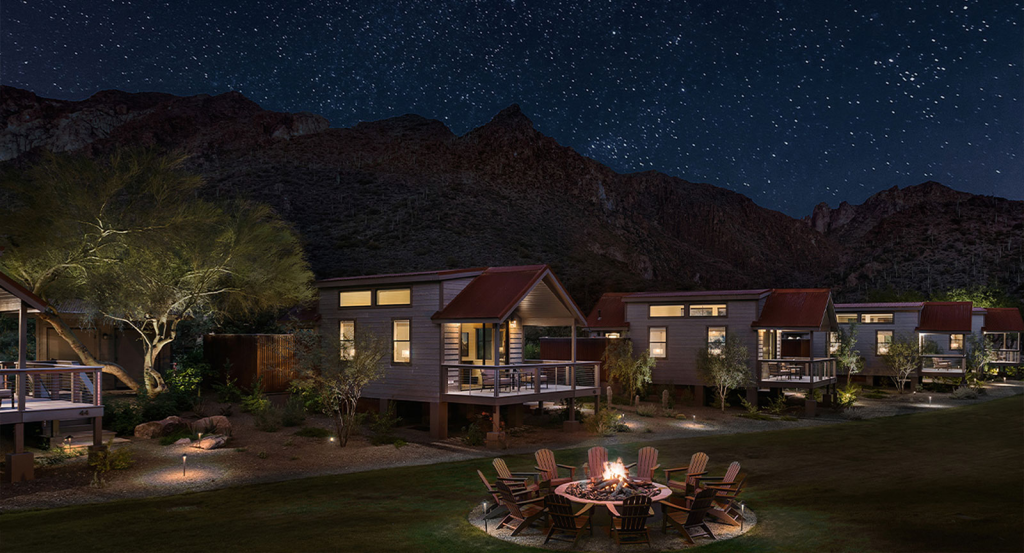 Sky View cabins at night with a firepit and chairs